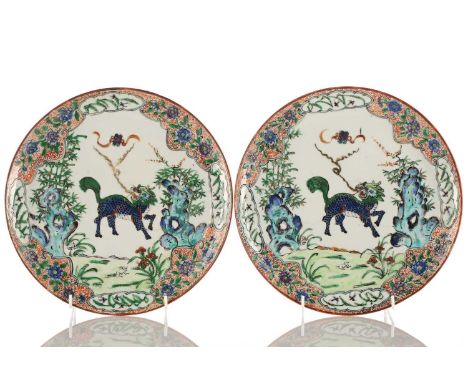 A pair of Chinese famille verte Qilin plates, Qing, 19th century, the beast facing right with smoke issuing from its mouth be