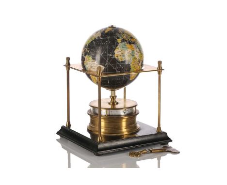 A Royal Geographic Society World clock with rotating terrestrial globe within a gilt metal chassis on an ebonized moulded woo