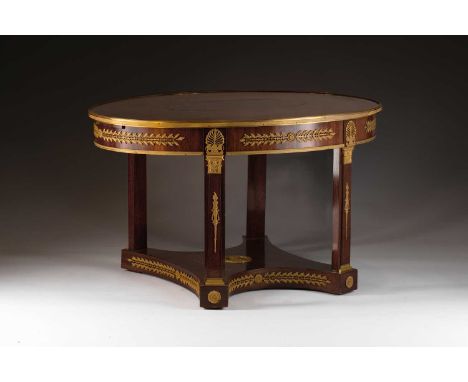 An Empire-style ormolu mounted mahogany oval center table, possibly Spanish first quarter of the 19th century. The figured to