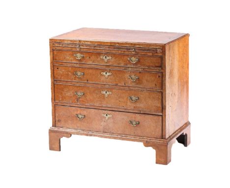 A George I figured walnut caddy topped bachelor's chest of four long drawers. With quartered top and brushing slide below. On