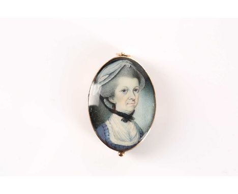 A Georgian miniature portrait mourning pendant, painted on ivory, with hair sample verso, gold mounted with seed pearl monogr