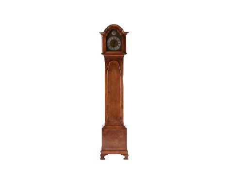 An early 20th century walnut grandmother clock, the domed hood above brass dial with 'Tempus Fugit' disc to the arch and insc