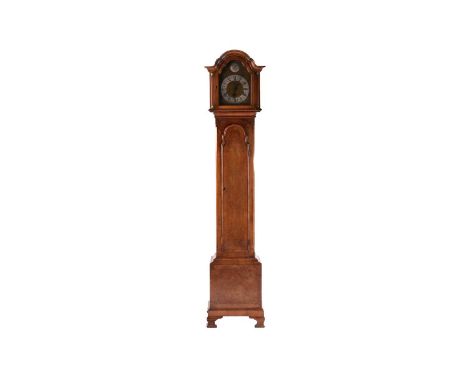 An early 20th century walnut grandmother clock, the domed hood above brass dial with 'Tempus Fugit' disc to the arch and insc