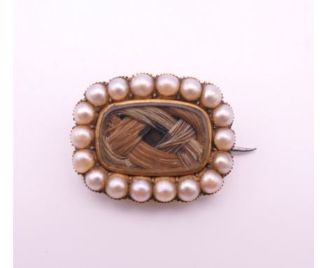 A George III seed pearl and hair plait mourning brooch, inscribed to reverse. 1.5 x 2 cm.