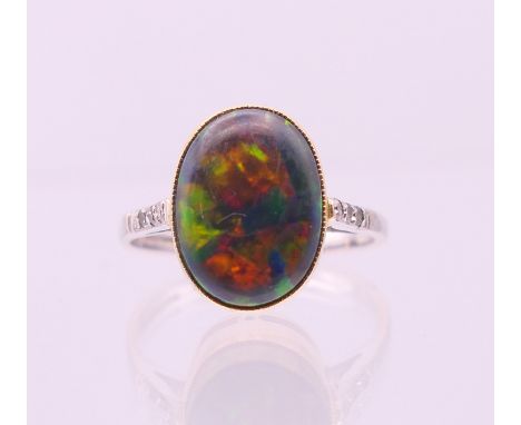 An 18 ct white and yellow gold opal ring. Ring size O.