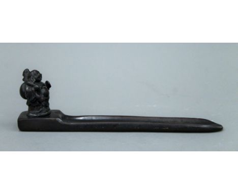 An incense stick holder surmounted with a model of Buddha. 22.5 cm long.