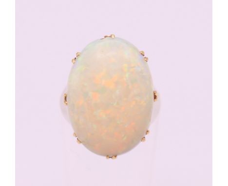 An 18 ct gold opal cabochon ring. Ring size I.