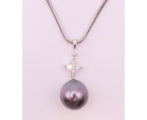An 18 K white gold, diamond and pearl pendant necklace.  Pendant 2.75 cm high including suspension loop, chain 50 cm long. 