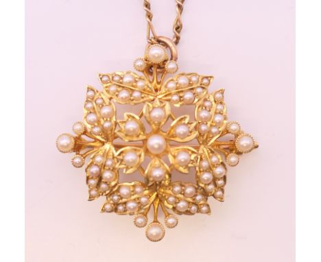 A 15 ct gold and seed pearl pendant/brooch on a 9 ct gold chain.  Pendant 3 cm high, chain 42 cm long. 9.4 grammes total weig