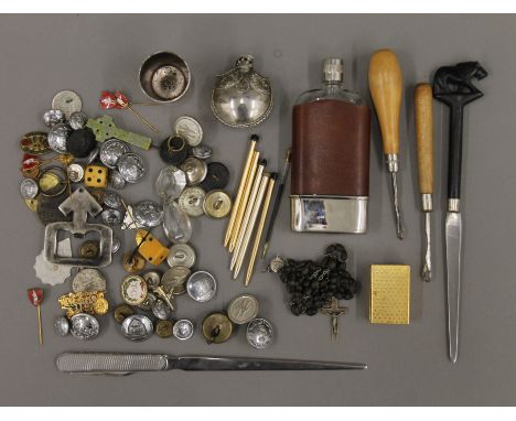 A display tray of vintage collectable's, including a quantity of uniform buttons, badges and pins, a perfume bottle, ebony ro