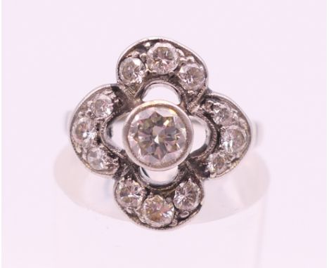 A platinum (tested) ring central diamond surrounded by 4 arcs of 3 diamonds. Total diamond weight approximately 1.3 carats. R