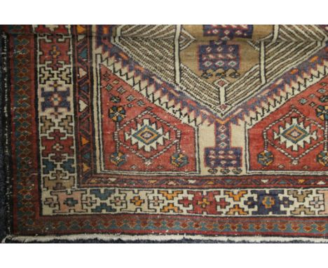 Three vintage red ground rugs. 