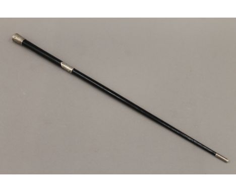 An ebony and silver stick/baton. 51.5 cm long.