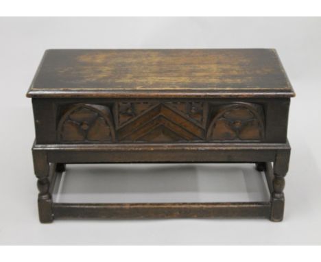 An early 20th century small carved trunk on stand. 60.5 cm wide.