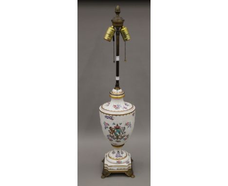 A Chinese armorial type urn shaped porcelain vase and cover, now fitted as a lamp, with brass fittings. 79 cm high overall.