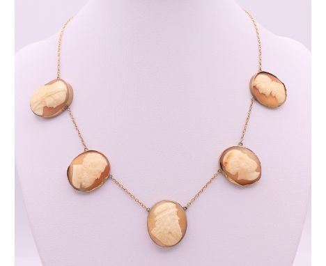 Five antique shell portrait cameos of classical subjects formed as a 9 ct gold necklace.  Approximately 38 cm long. 