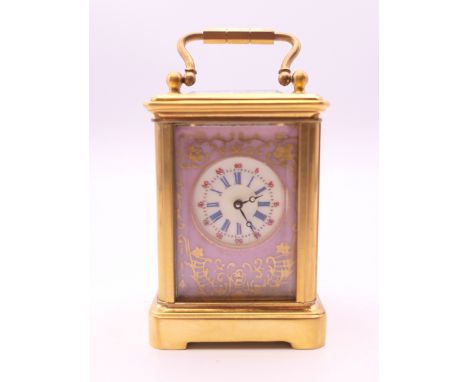 A miniature porcelain mounted carriage clock.  6 cm high.