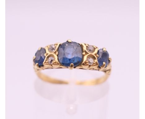 An 18 ct gold, sapphire and diamond ring. Ring size K/L.