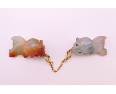 A Chinese gold and jade brooch formed as two fish.  Each fish 2.5 cm long. 