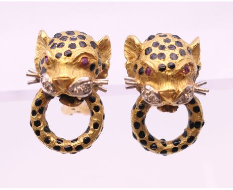 A pair of 18 K gold, ruby, diamond and enamel leopard mask form earrings.  2 cm high. 18.4 grammes total weight.