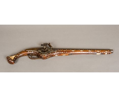 A bone and mother-of-pearl inlaid wheel lock pistol. 63.5 cm long.
