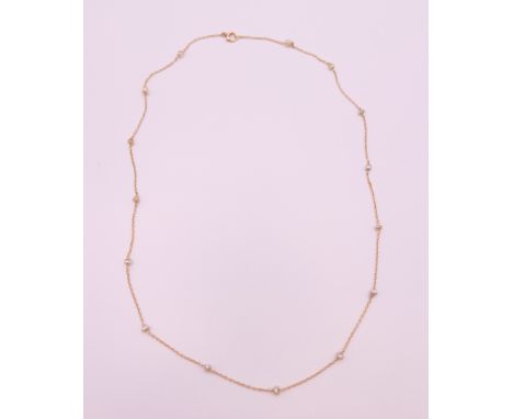 A cased 9 ct gold and seed pearl necklace.  44 cm long. 1.7 grammes total weight.