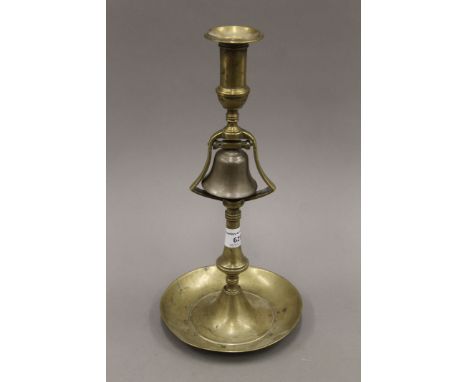 An antique brass and bell metal tavern candlestick. 33 cm high.