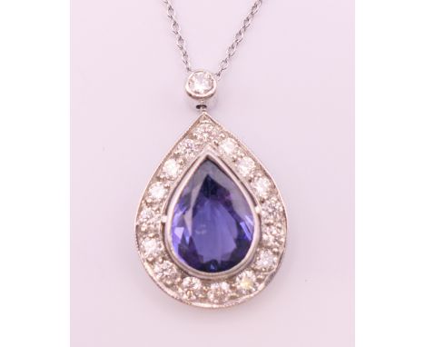 An 18 ct white gold pear shape tanzanite and diamond pendant on chain.  Pendant 2.5 cm high including suspension loop, chain 