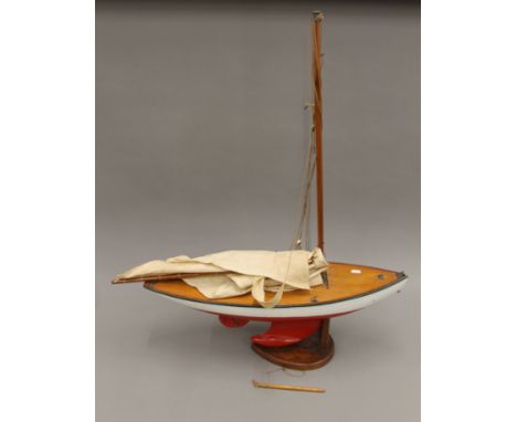 A vintage pond yacht on stand. 70 cm long x 91 cm high.