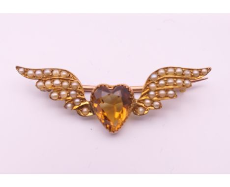 A 9 ct gold seed pearl and citrine sweetheart brooch.  4 cm long. 2.7 grammes total weight.