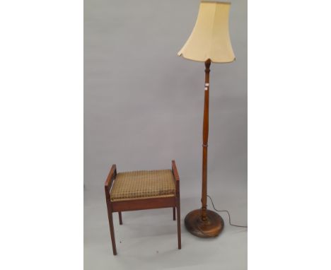 A standard lamp and a piano stool. 