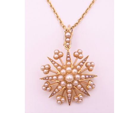 A 14 ct gold and pearl star form pendant and chain, cased.  Star 3 cm diameter, chain 43 cm long. 8.5 grammes total weight.