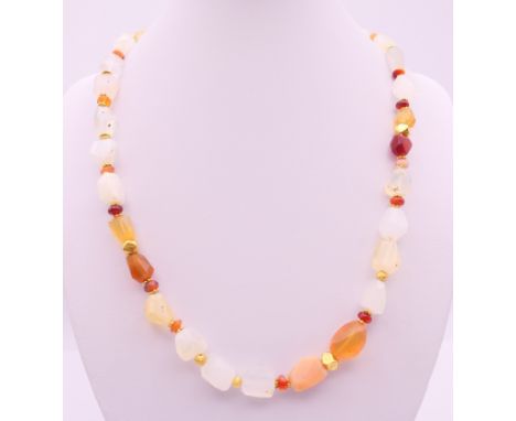 A rough cut opal and gold mounted necklace.  48 cm long. 