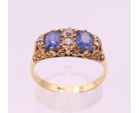 A 15 ct gold diamond and sapphire ring. Ring size R/S.