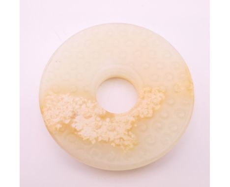 A white jade roundel.  6 cm diameter.