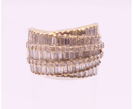 A Contemporary 14 K gold tapered baguette cut diamond ring. Total diamond weight approximately 3 carats. Ring size L/M.