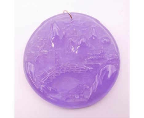 A gold mounted lilac jade pendant.  5.25 cm diameter.