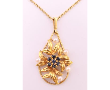 A 9 ct gold sapphire and pearl pendant on a 9 ct gold chain.  Pendant 3 cm high excluding suspension loop, chain 40 cm long. 