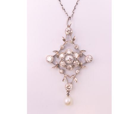 An Edwardian unmarked white gold or platinum diamond and pearl set floral pendant on chain.  Pendant 4 cm high, chain 45 cm l