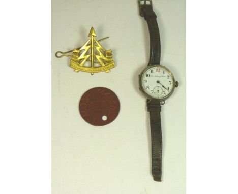 A silver cased wrist watch "The Military Watch", having white enamel dial with subsidiary seconds and inscribed as above, on 