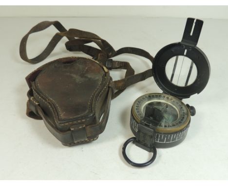 A WWII marching compass in leather case with strap
