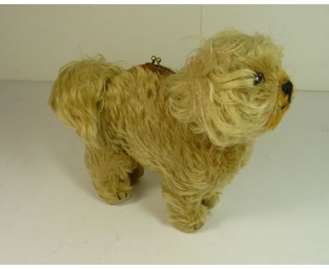 A novelty toy dog/purse, the light plush coloured Pekinese type dog with glass eyes, black stitched mouth and claw detail and