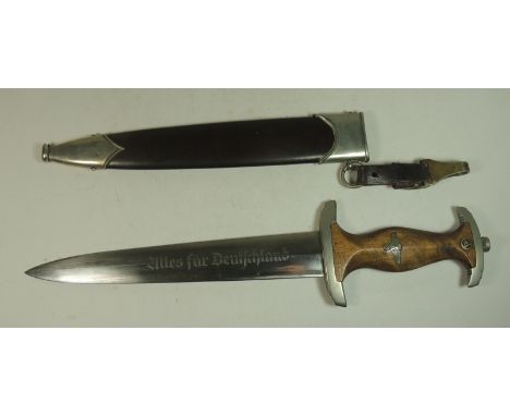 A Third Reich SA dagger the wooden grip with nickel metal mounts, inset enamelled "SA" rune, eagle and swastika, the blade et