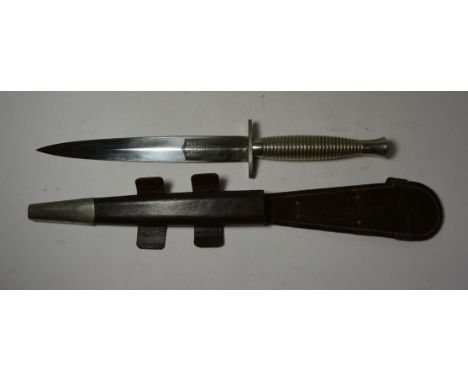 A Fairburn Sykes Wilkinsons blade Commando fighting knife with white metal grooved grip, blade with Wilkinson Sword mark and 