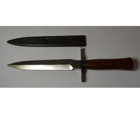 A WWI French Trench Knife having plain wood grip, double edged blade the ricasso stamped "41 Gonon", with flat cross guard an