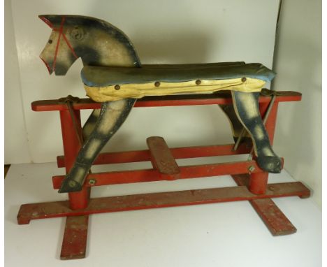 A small early 20th Century rocking horse, the painted wood horse with original padded seat and on painted wood trestle base, 