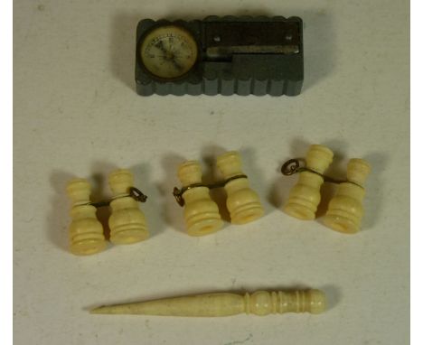 Two miniature late Victorian binoculars each set with a Stanhope of French views; another similar lacking Stanhope; a small b
