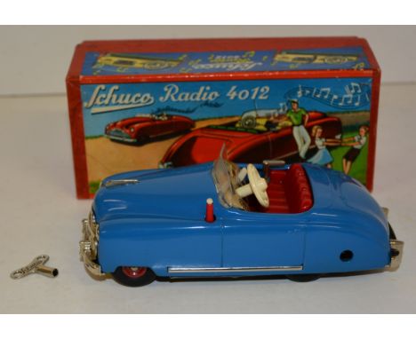 A Schuco Radio 4012 Radio Car, blue, with key in original box.  The Thorens movement playing "In My Merry Oldsmobile" as prin