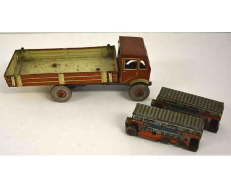A clockwork tinplate lorry, cream and light brown, with open back, marked "Made in England" to the cab and with attached key,