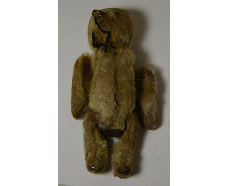 A Schuco miniature teddy bear having gold plush, white metal button eyes and black stitched nose, 12cms high ++very worn, one